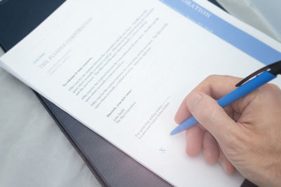 High angle view of man reading book