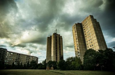 Skyscrapers against cloudy sky