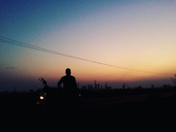 Silhouette of man against sky during sunset