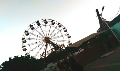 Low angle view of ferris wheel against clear sky