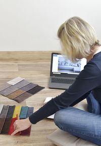 Woman using mobile phone while sitting on table