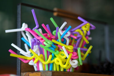 Close-up of colorful straws on table