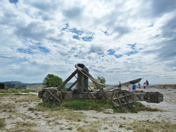 Abandoned truck on field against sky