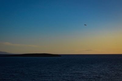 Scenic view of sea against clear sky during sunset