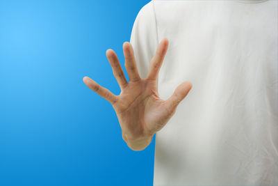 Close-up of hand against white background