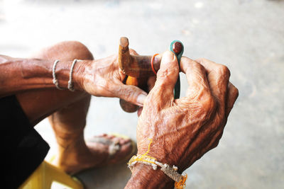 Midsection of man holding slingshot