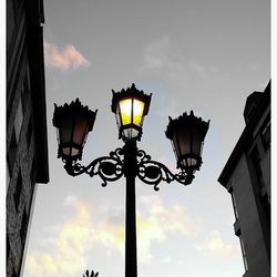 Low angle view of illuminated street light against sky