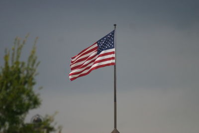 Low angle view of flag against sky