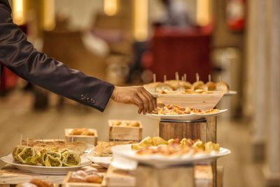 Person preparing food on table in restaurant