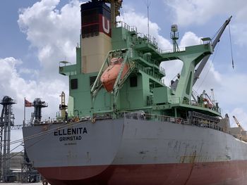 Low angle view of ship moored at harbor against sky