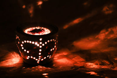 Close-up of illuminated lamp against dark background