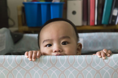 Portrait of boy in crib