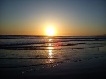 Scenic view of sea against clear sky at sunset