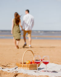 Couple of a man and a woman on a date on the beach by the sea.  walk picnic of two lovers in nature