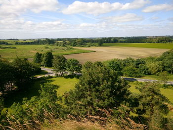 Scenic view of golf course against sky