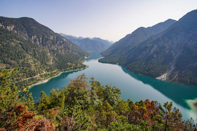 Scenic view of lake and mountains against clear sky