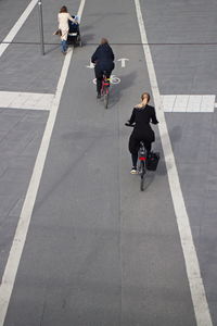 Two women riding bicycles on street