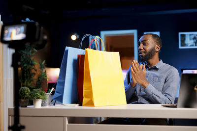 Portrait of young man holding gift