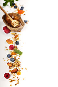 High angle view of fruits on table against white background