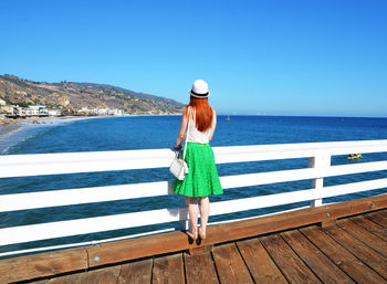 Full length of a woman standing against clear sky