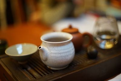 Close-up of coffee cup on wooden table