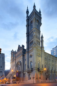 Low angle view of illuminated buildings against sky