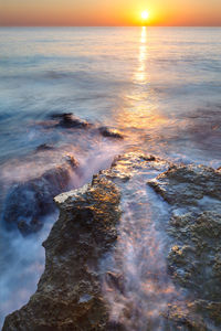 Scenic view of sea against sky during sunset