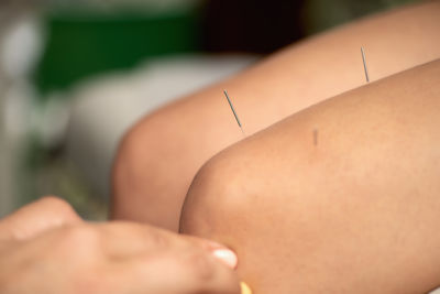 Cropped hand of woman holding thermometer