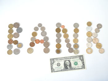 High angle view of coins on white background