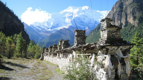 Panoramic shot of building and mountains against sky