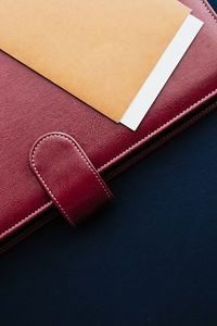 Close-up of diary with envelope on table