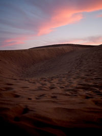 Scenic view of desert against sky during sunset