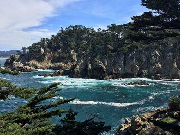 Scenic view of sea and rocks against sky