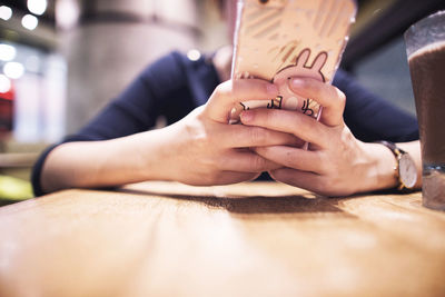 Close-up of a woman text messaging