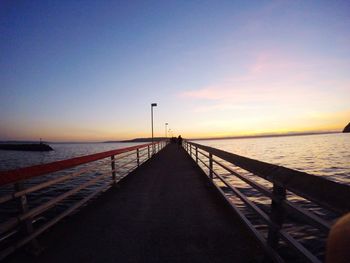 Long wooden jetty leading to calm sea