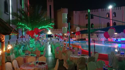 Illuminated christmas lights in restaurant at night