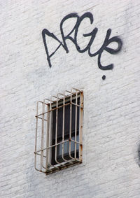 Graffiti text over window of building