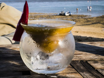 Close-up of drink on table at beach