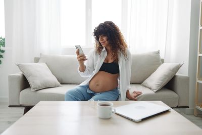 Young woman using laptop at home