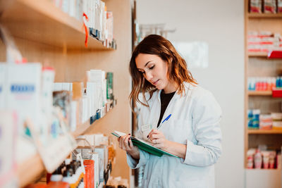 Female pharmacist working at store