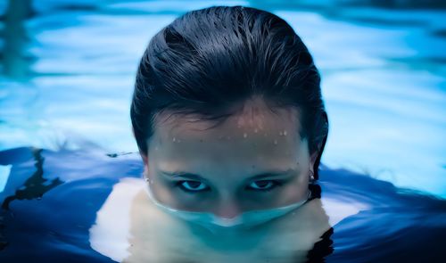 Portrait of girl swimming in pool