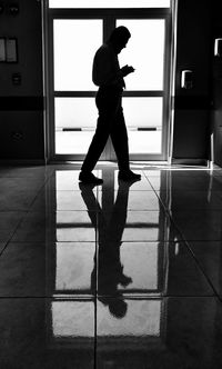 Reflection of silhouette man on floor at home