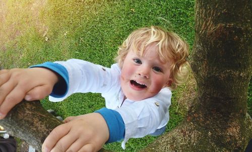 Portrait of boy smiling in grass