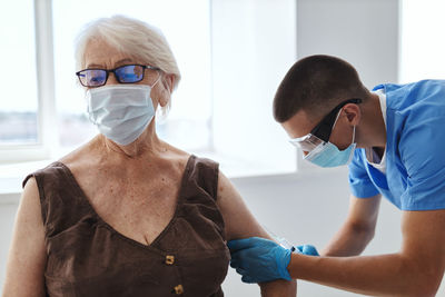 Doctor injecting vaccine to patient