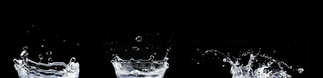 Close-up of water splashing in glass at night