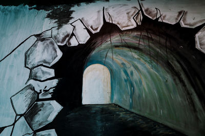 Close-up of stone wall with reflection in water