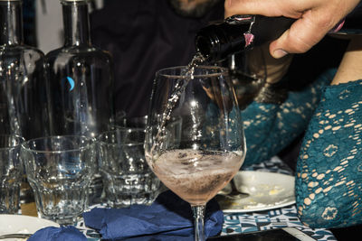 Midsection of wineglass on table