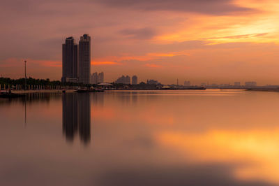 Scenic view of lake by sea against romantic sky at sunset
