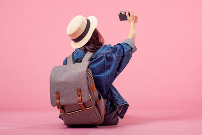 Rear view of woman photographing camera