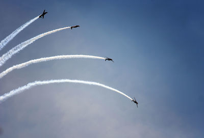 Low angle view of airplane flying against sky